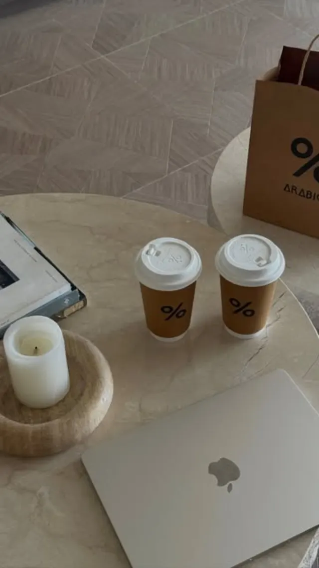 Reel: two coffees and a laptop on a stone table