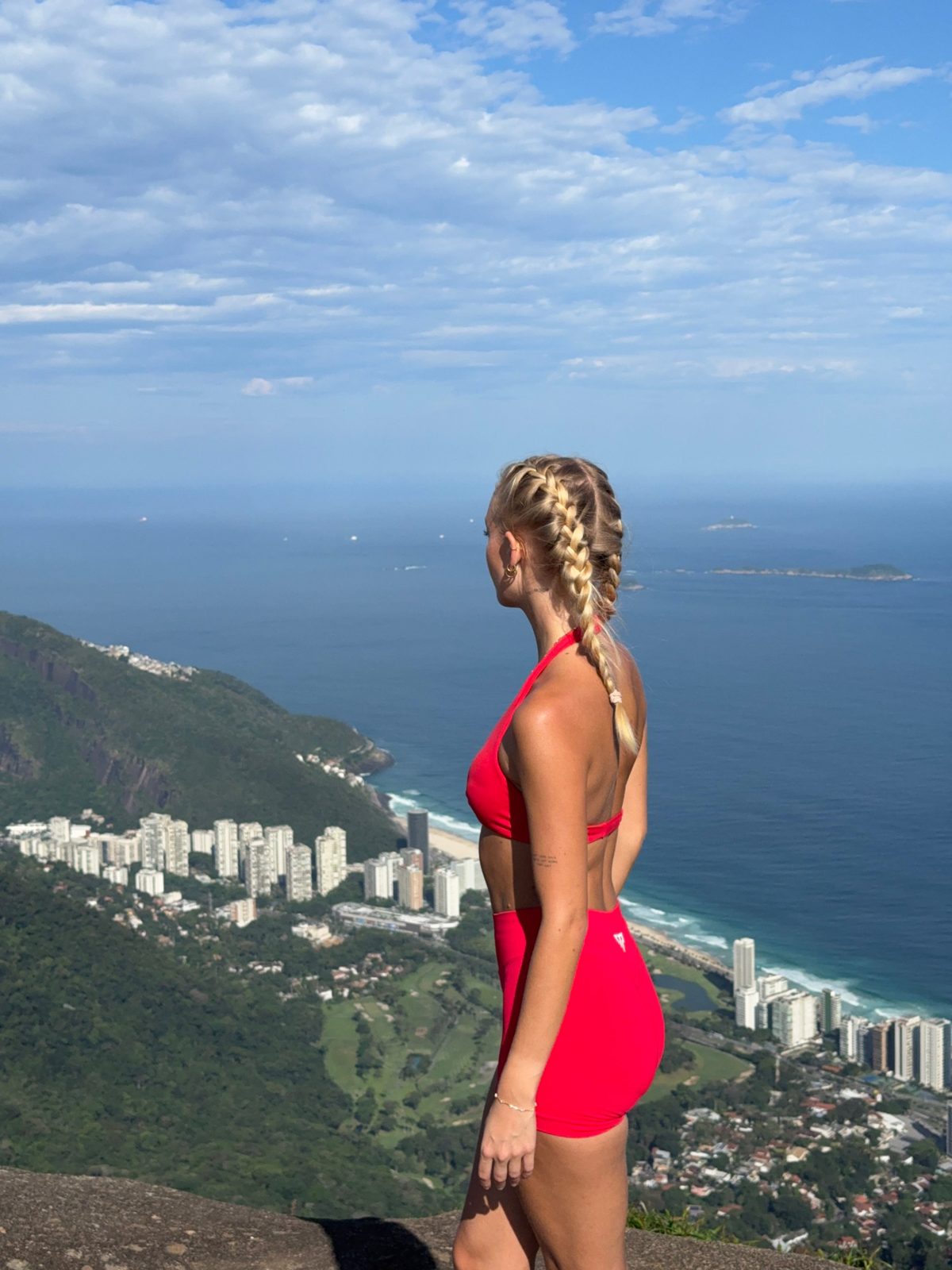Lilli looking out over the ocean from a mountain